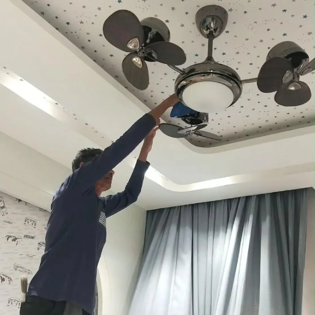 Ceiling fan being cleaned